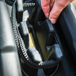 Close-up of a hand securing a Fatsac heavy-duty dock line on a boat cleat.