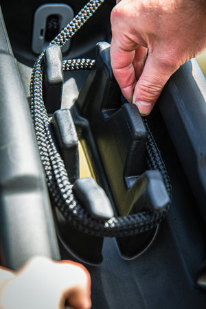 Close-up of a hand securing a Fatsac heavy-duty dock line on a boat cleat.