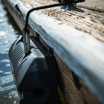 Fatsac boat bumper floats near the surface, tied to a dock line.