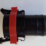 Close up of black plug with red band.