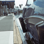 Close-up of a Fatsac fender at a marina with dock line and bumper attached.