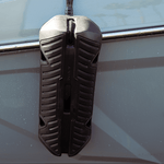 Fatsac boat fender with bungee cable hanging on a vessels side.